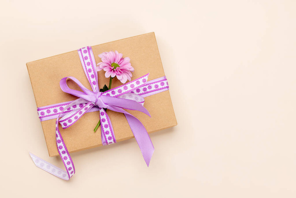 Handmade gift box with purple ribbon and flower. Flat lay with copy space - Photo, image
