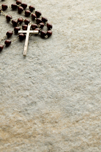 Image of close up of rosary and copy space on stone background. Easter, religion, tradition and celebration concept. - Fotografie, Obrázek