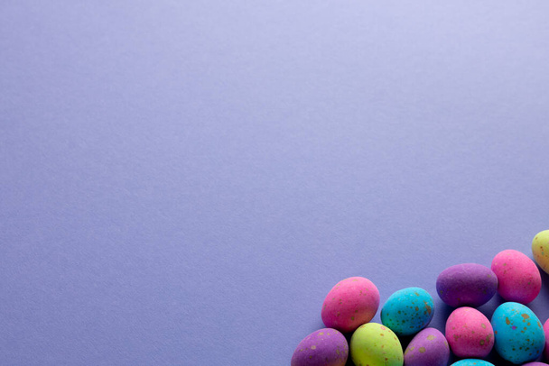 Image of multi coloured easter eggs with copy space on purple background. Easter, religion, tradition and celebration concept. - Fotoğraf, Görsel