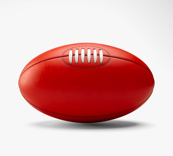 A generic unbranded aussie rules football ball on an isolated studio background - 3D render - 写真・画像