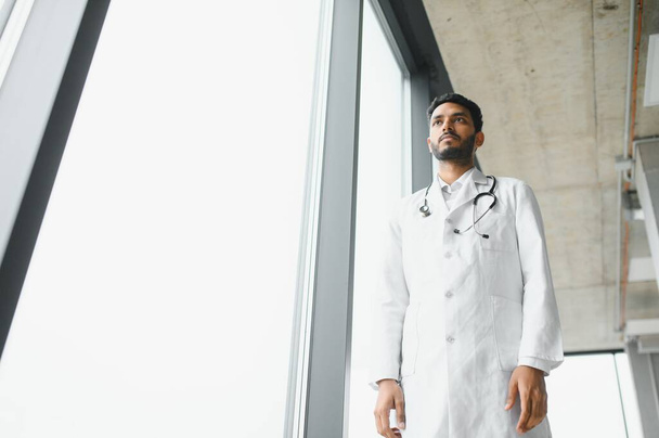 Portrait of confident Asian Indian medical doctor standing at hospital building. - Foto, Imagem
