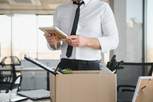 business, firing and job loss concept - fired male office worker with box of his personal stuff - Photo, Image