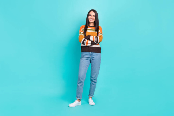 Full length photo of pretty confident woman wear striped sweater smiling arms crossed isolated turquoise color background. - Fotó, kép