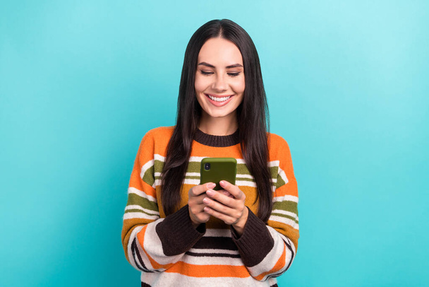 Photo of young cheerful positive woman apple modern smartphone user writing message telegram bot online isolated on aquamarine color background. - Foto, Bild