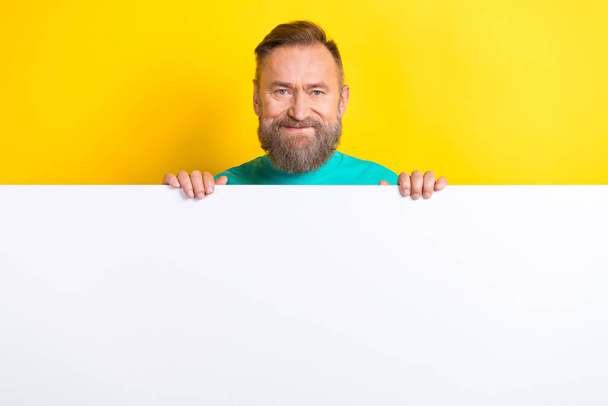 Photo of nice cheerful man wear trendy clothes hand hold empty space presenting opening new store isolated on yellow color background. - Фото, зображення