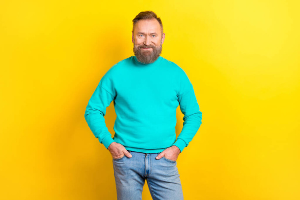Photo of retired confident man wear teal clothes hand in pockets finished work task isolated on yellow color background. - Photo, image