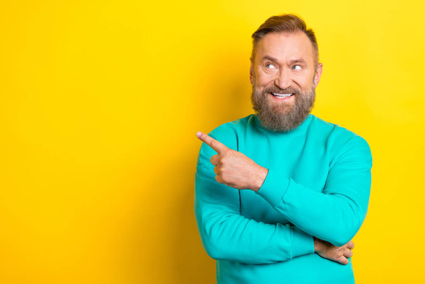 Photo of cheerful man wear trendy clothes arm demonstrate empty space novelty interesting offer isolated on yellow color background. - Foto, immagini