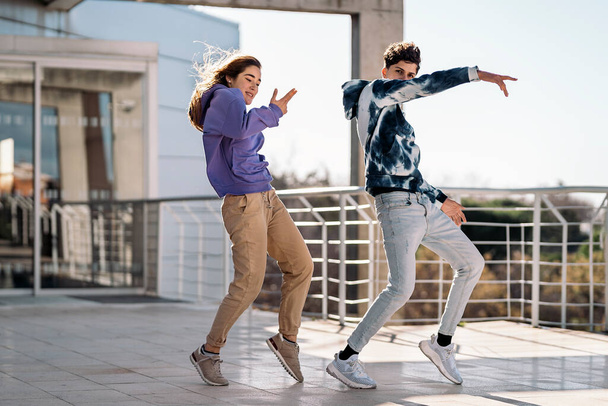 Stock photo of cool girl and her friend doing dance moves and having fun. - Foto, immagini