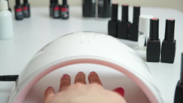 Drying the top for gel polish in an ultraviolet LED lamp. Manicure at home yourself, beauty salon. - Footage, Video