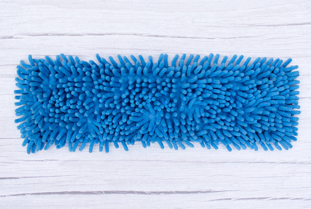 Blue microfiber mop. Modern mop cloth on wooden floor - Zdjęcie, obraz