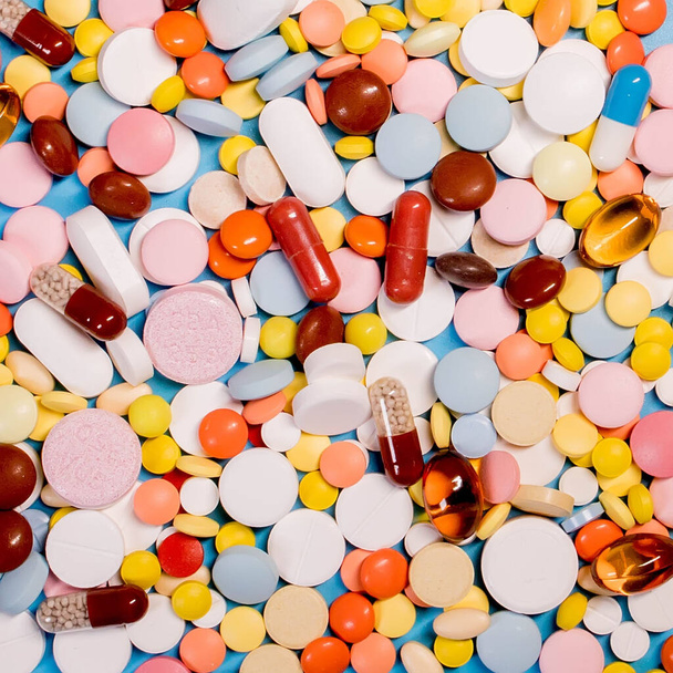 Many colorful different medicines and pills on top. The concept of medical treatment. - Fotoğraf, Görsel