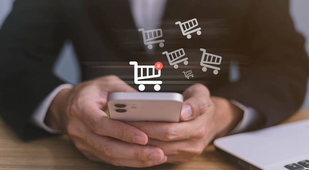 Business people use computer laptop for ordering online shopping on a shopping cart virtual screens. And online payment option or digital wallet online transaction and e-commerce technology concept. - Photo, Image
