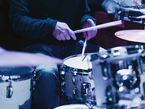Musician playing the drums during a concert, no faces shown, shallow depth of field - Photo, Image