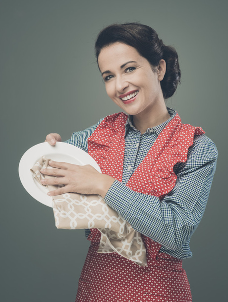 Housewife drying and polishing dish - Фото, изображение