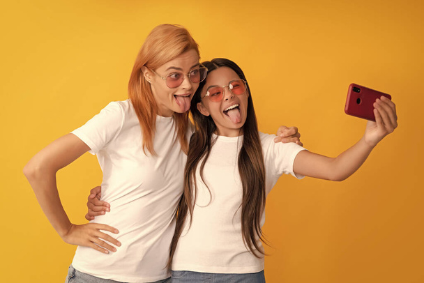 selfie family. modern life. mobile technology. having video call. mother and daughter vlogging. online communication. mom and kid bloggers. happy funny woman and girl take selfie with smartphone. - Fotoğraf, Görsel