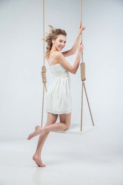 Young bare-footed girl by swing looking in camera - Foto, immagini