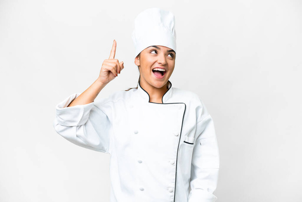 Young woman Chef over isolated white background intending to realizes the solution while lifting a finger up - Photo, Image