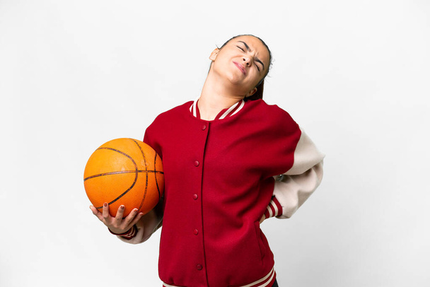 Молода жінка грає в баскетбол над ізольованим білим тлом, що страждає від беккача за те, що зробила зусилля
 - Фото, зображення