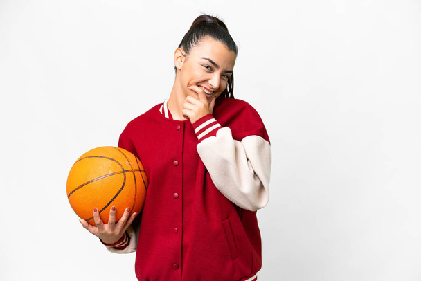 Young Woman playing basketball over isolated white background happy and smiling - Фото, изображение