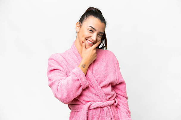 Young woman in a bathrobe over isolated white background smiling - Photo, Image