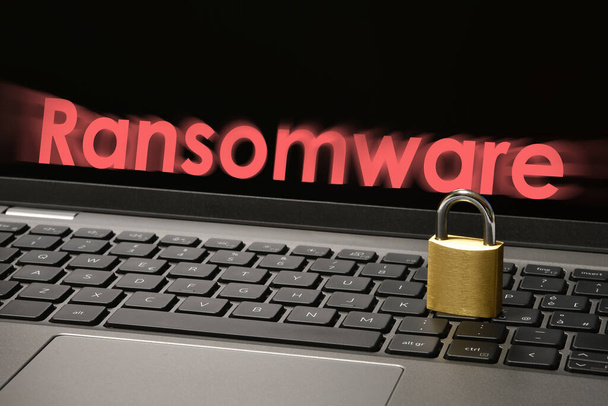 ラップトップキーボードの閉じた南京錠と画面上の「ランサムウェア」テキストとコンピュータセキュリティの概念。サイバー脅威の概念イメージ. - 写真・画像