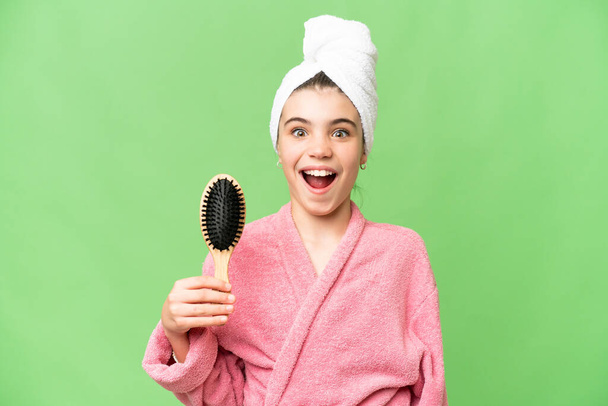 Young girl with hair comb with surprise and shocked facial expression - Photo, Image