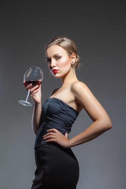 Woman in black dress with wine glass - Photo, Image