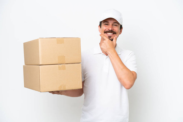 Delivery caucasian man isolated on white background happy and smiling - Photo, Image