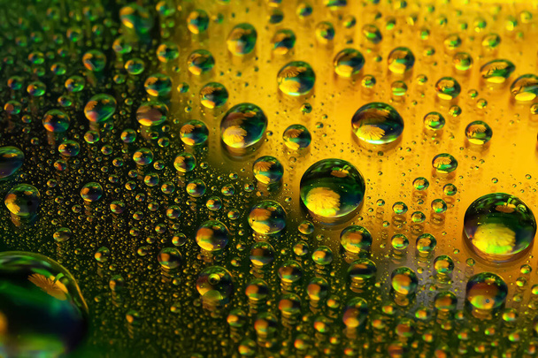 Drops of water. Abstract background. Colored macro texture many drops. Rainbow wet gradient. Heavily textured image. Shallow depth of field. Selective soft focus - Valokuva, kuva