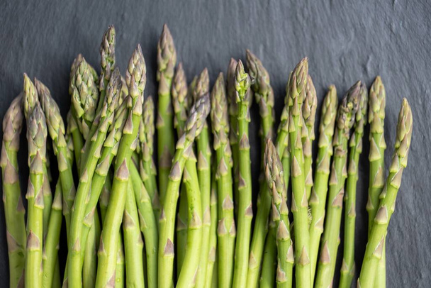 fresh green asparagus on a black background - Foto, imagen