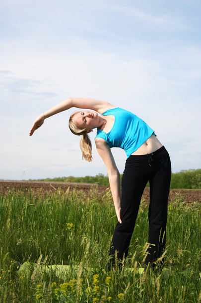 Young woman doing yoga - Фото, зображення