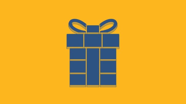 Blue Gift box icon isolated on orange background. Merry Christmas and Happy New Year. 4K Video motion graphic animation. - Filmati, video