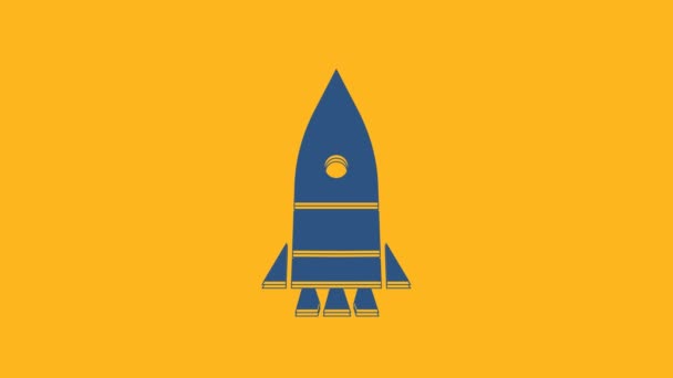 Blue Rocket ship icon isolated on orange background. Space travel. 4K Video motion graphic animation. - Video