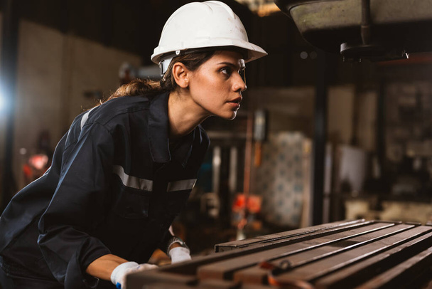 Confident female technician engineer worker checking and inspecting machine at manufacturing factory, Machinery maintenance concept - Φωτογραφία, εικόνα