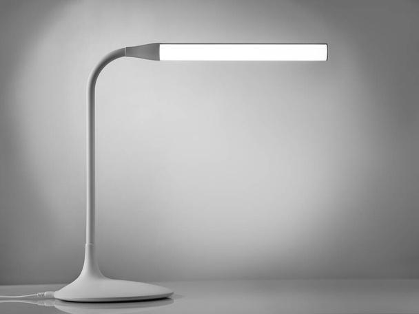 Minimalistic table lamp on a gray background - Foto, Bild