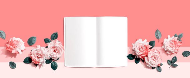 White blank notebook with pink roses overhead view - flat lay - Foto, afbeelding