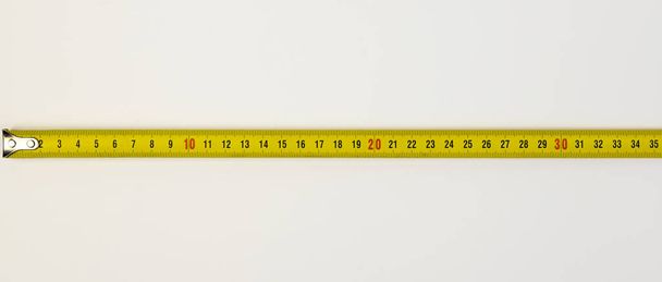 A tool for measuring length. Construction measuring tape on a white background - Photo, Image