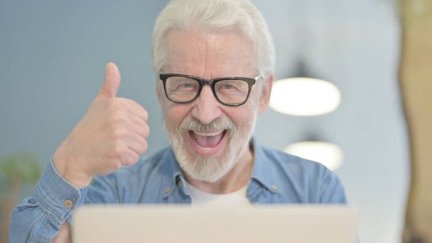 Close Up of Thumbs Up by Senior Old Man Working on Laptop - Фото, зображення