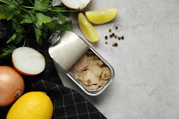 Flat lay composition with tin can of tasty cod liver and different products on textured table. Space for text - 写真・画像