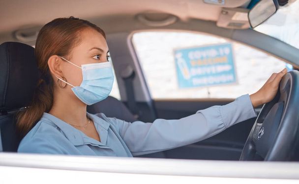 Covid vaccine, car drive and woman with face mask for safety, compliance and healthcare at an outdoor clinic or hospital. Person in vehicle at covid 19 drive thru for corona virus medical vaccination. - Foto, Imagen