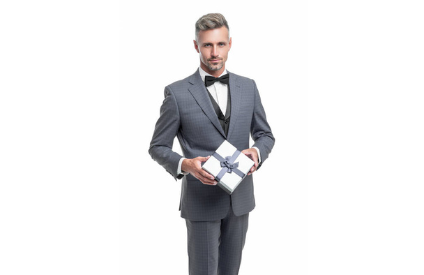 man in blue suit with gift box isolated on white. valentines day. - 写真・画像