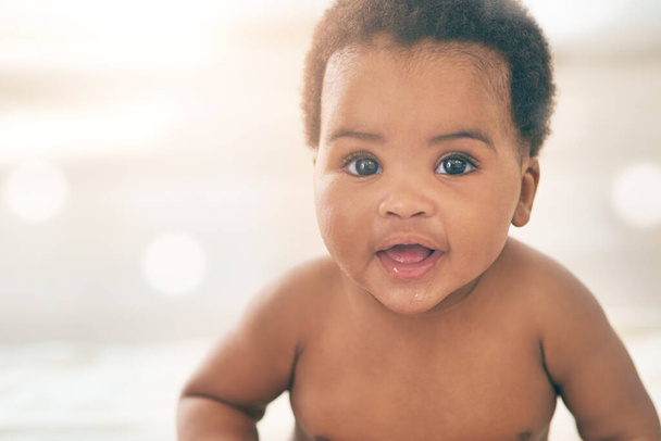 Cute baby, black kid and happy portrait with bokeh, mockup and space in nursery room, happiness and relax. Young infant child, girl and smile of healthy development, growth and adorable face in house. - Photo, image