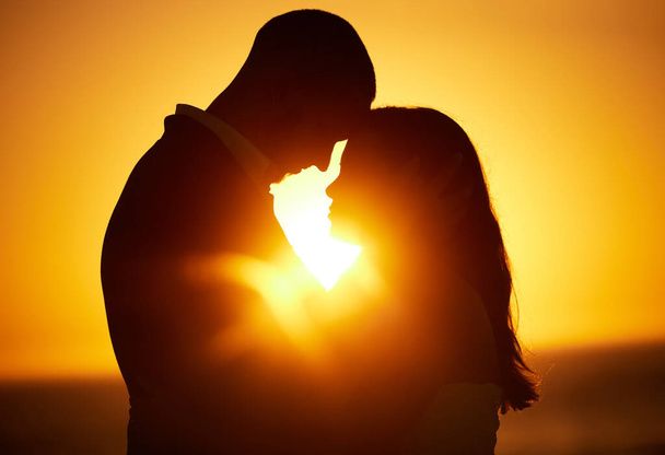 Silhouette, sunset and couple on honeymoon love bonding, hugging and enjoying quality time together in Los Angeles. Romantic woman and partner on holiday vacation in a dark night on Valentines day. - Photo, image