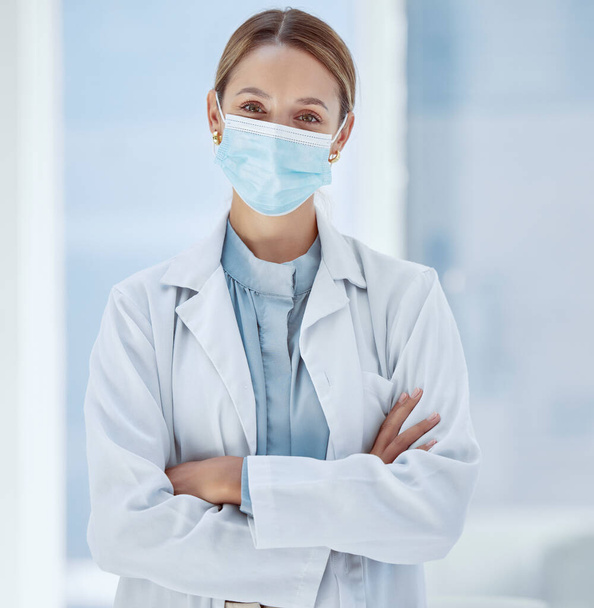 Woman, healthcare and covid face, mask rules with proud doctor working in a hospital, ready and confident. Health care professional leader work during pandemic, focused on helping sick people. - Foto, afbeelding