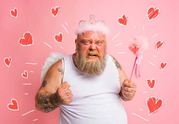 Fat angry man with tattoos acts like a fairy - Zdjęcie, obraz