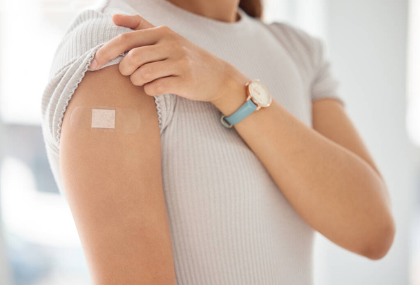 Covid, vaccine and woman with plaster on arm, medical shoulder injection dose and immunization bandage. Corona virus immunity, immune system cure or wellness and female patient healthcare vaccination. - Foto, Bild