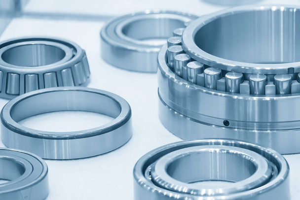 The cylindrical rolling bearing parts in light blue scene. The heavy mechanical part manufacturing concept. - Foto, Bild