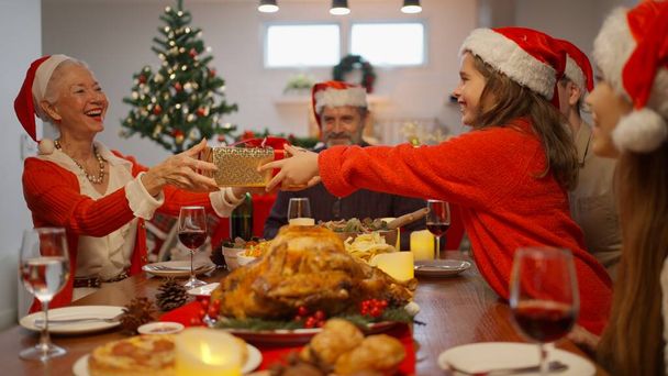 Merry Christmas, Big family with Christmas gift box, Happy people with Santa hat celebrating Christmas day together, Family with Christmas celebration concept - Valokuva, kuva