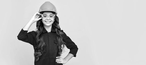 very professional. safety glasses for repairing. labor day. Child builder in helmet horizontal poster design. Banner header, copy space - Φωτογραφία, εικόνα