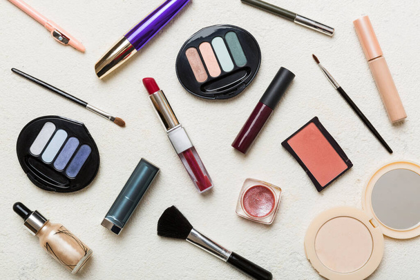 Professional makeup tools. Top view. Flat lay. Beauty, decorative cosmetics. Makeup brushes set and color eyeshadow palette on table background. Minimalistic style. - 写真・画像